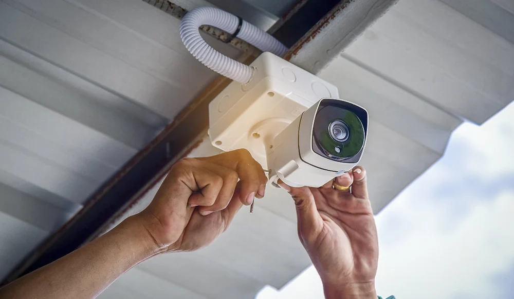 Home technician installing cctv camera