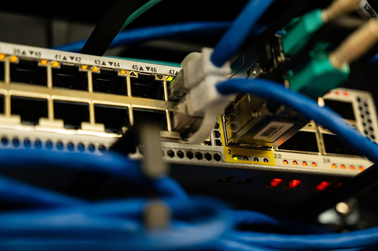 Home Close-up image of ethernet cables plugged into a network switch, showcasing IT infrastructure.
